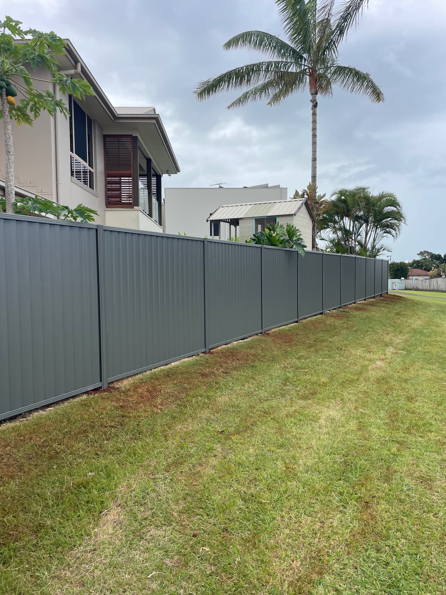 New grey Colorbond boundary fence after replacement