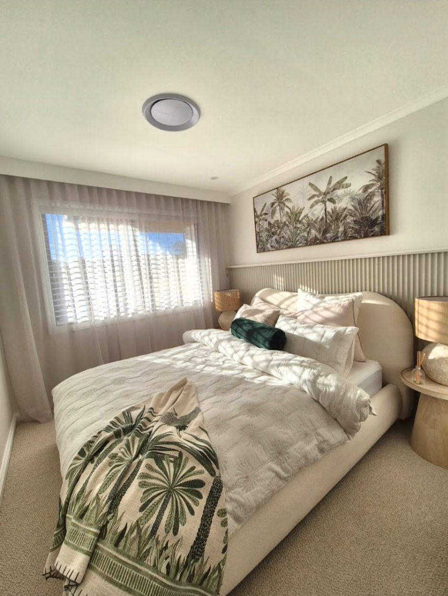 Bedroom with VJ panelled bedhead wall and styled finish